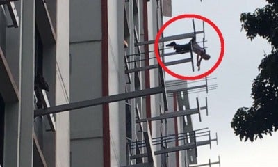 Man Survives Eight Storey Jump After His Clothes Snagged Onto Rack, Dangles Mid-Air - World Of Buzz