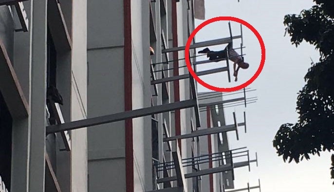 Man Survives Eight Storey Jump After His Clothes Snagged Onto Rack, Dangles Mid-Air - World Of Buzz