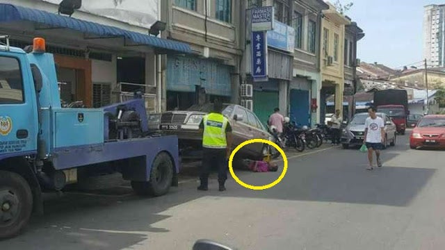 To Prevent His Car From Being Towed Away, Man Goes Under It - World Of Buzz 6
