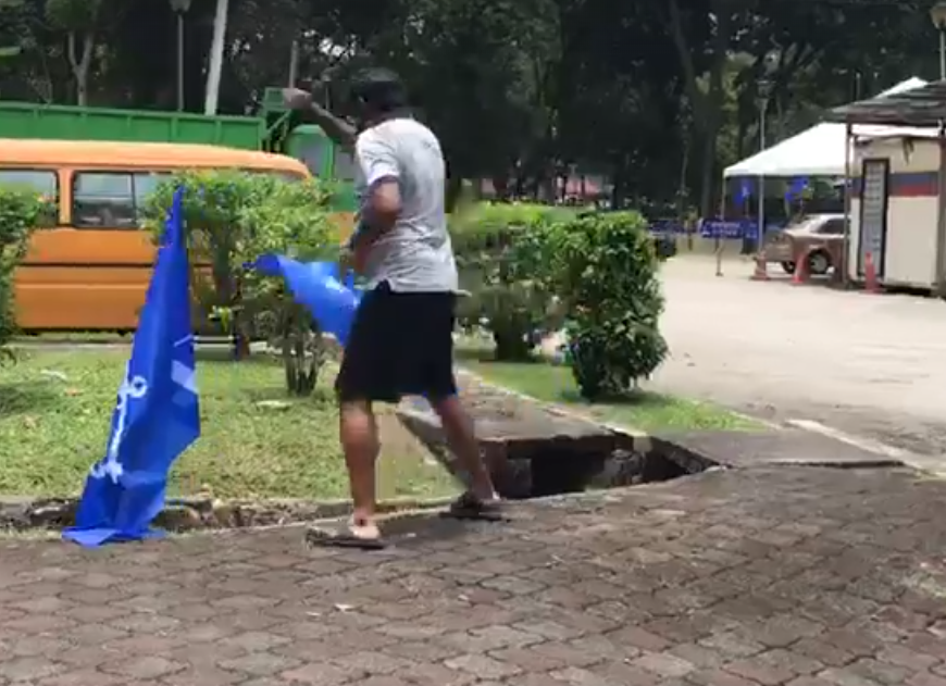 Police are Searching for 'Angry' Man Who Removed BN Flags in TTDI - WORLD OF BUZZ