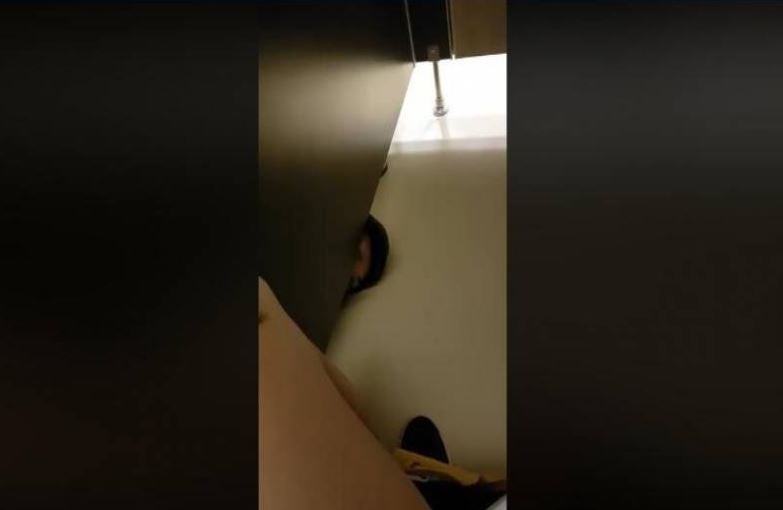 [Watch] Creepy Peeping Tom Pokes Head into Toilet Cubicle to Stroke Pooping Man's Leg - WORLD OF BUZZ 2