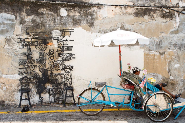 One of the 52 steel structures that grace walls and buildings of central George Town Penang. Image by Lonely Planet
