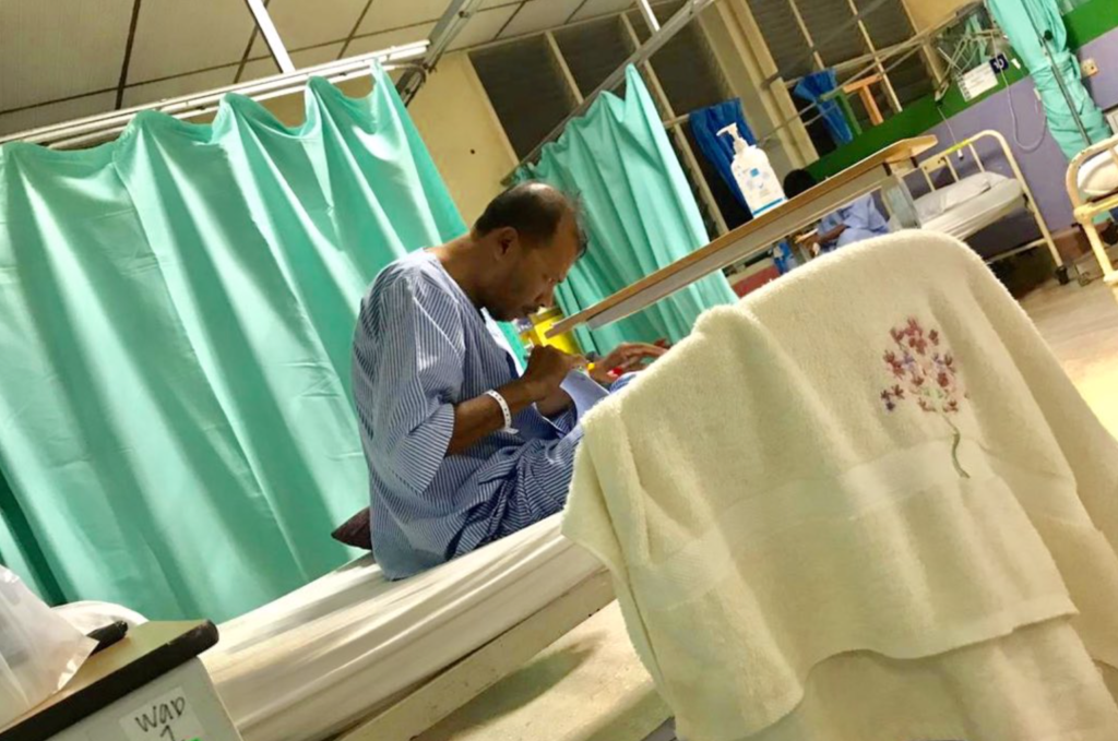 Passionate Teacher Photographed Marking Exam Papers On His Hospital Bed - World Of Buzz 1