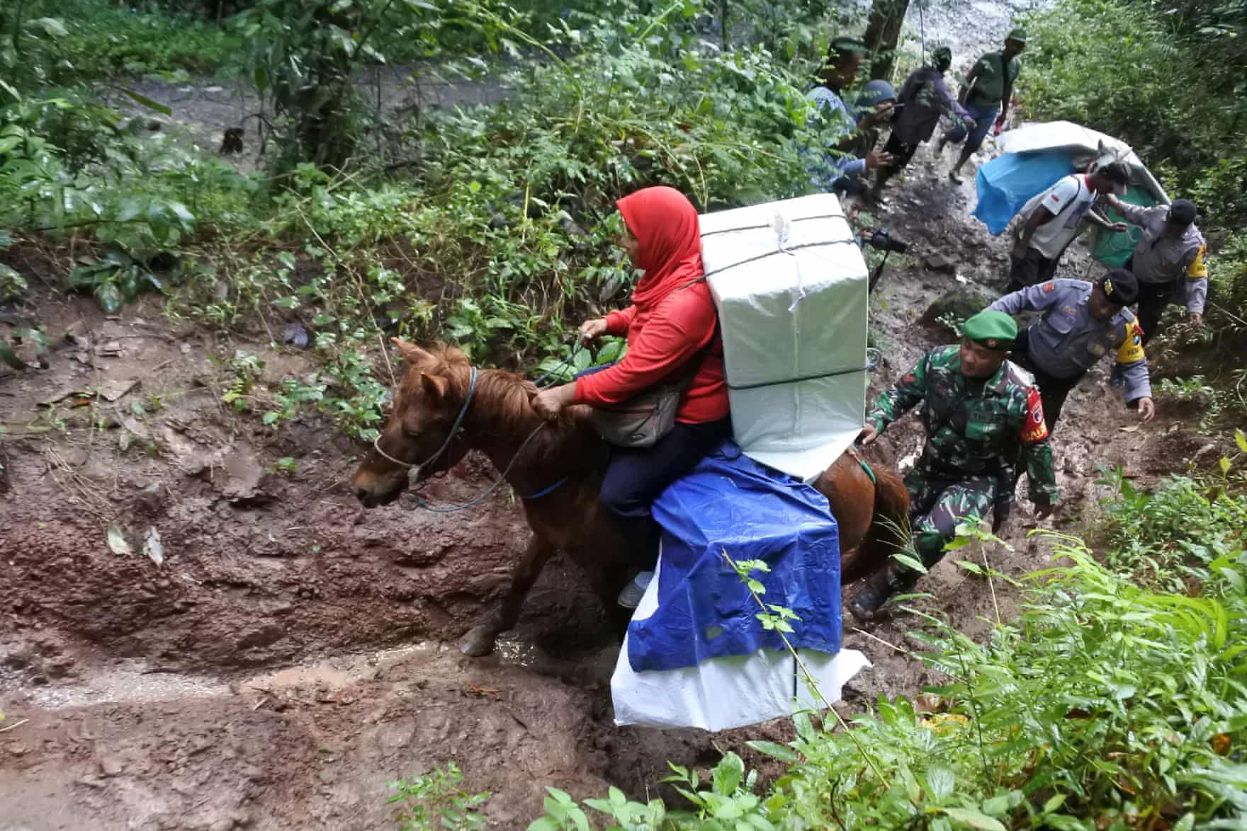 Photos of Indonesian Election Workers Riding Elephants & Crossing Rivers to Deliver Ballot Boxes Go Viral - WORLD OF BUZZ