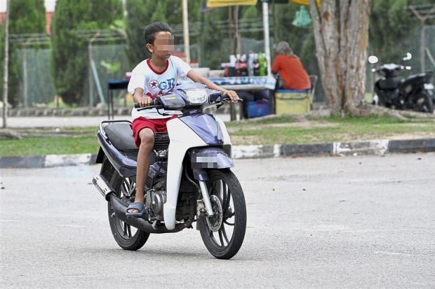 Boy Starts Crying After Getting Reprimanded For Riding A Motorbike Without A License And A Helmet - World Of Buzz 1