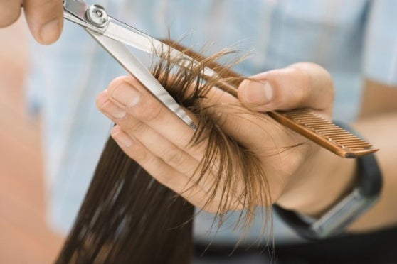 hairdresser cutting woman s hair in salon focus on hair hands and scissors close up 78119917 57f6a5a55f9b586c3535c1b6 e1562554140451