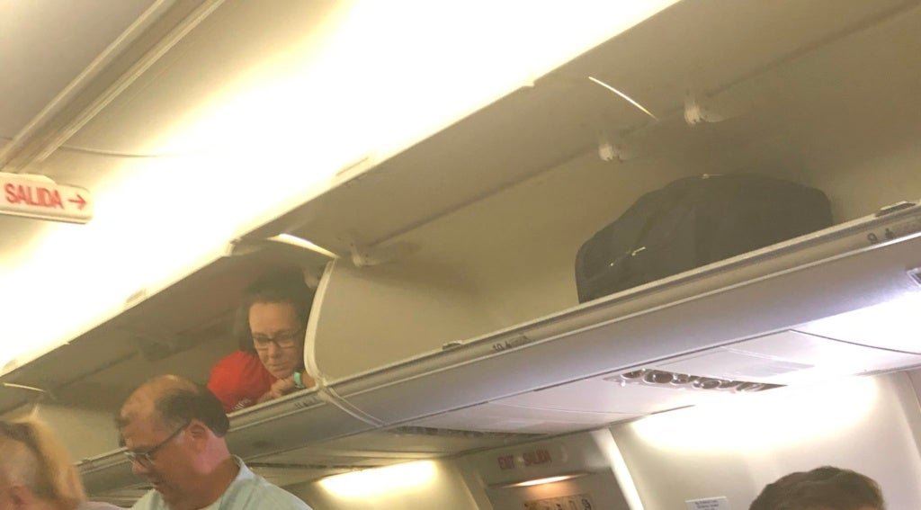 Cabin Crew Pulls A Prank On Passengers By Hiding Inside Overhead Luggage Bin - WORLD OF BUZZ 2