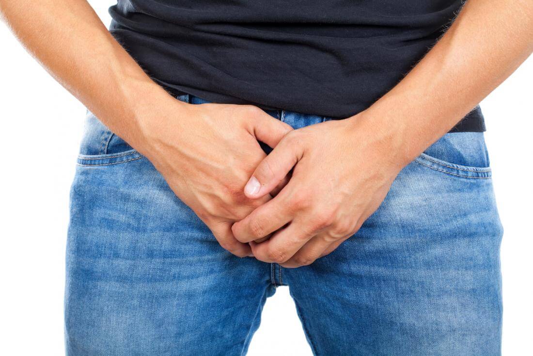 man holding his groin
