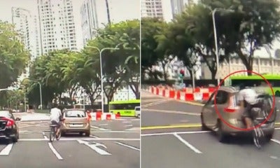 Watch: Cyclist Face Plants Into Car That Stopped At Red Light, Netizens In Stitches - World Of Buzz