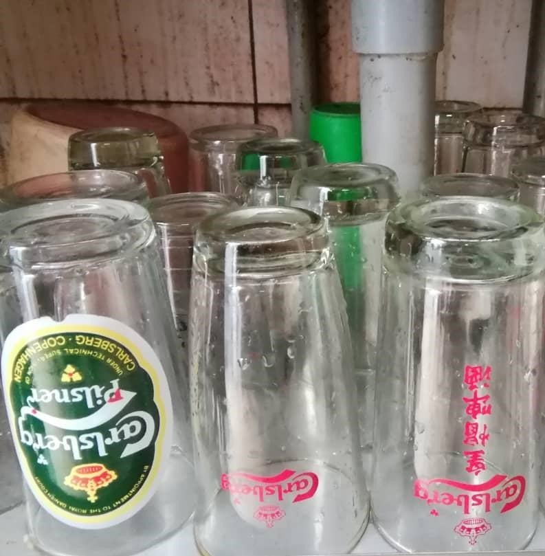 Hawker Summoned For Serving Drinks To Her Customers Using Cups With Beer Logo - World Of Buzz