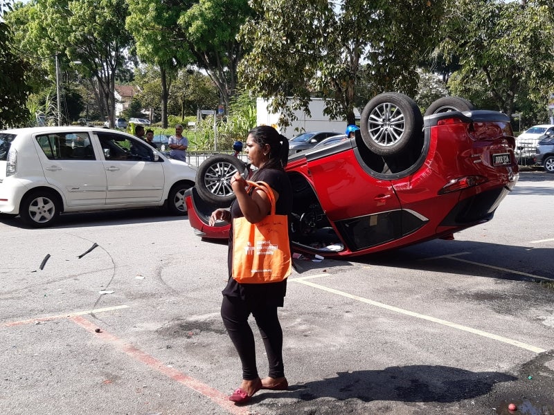 Unlicensed Foreign Worker Puts Car In Reverse Instead Of Drive, Overturns Cheras Woman's New - WORLD OF BUZZ