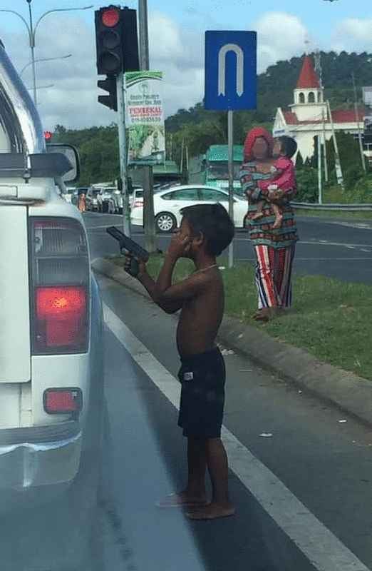 Young Boy In Sabah Uses Toy Gun To Scare People Into Giving Him Money, Gets Arrested By Police - WORLD OF BUZZ