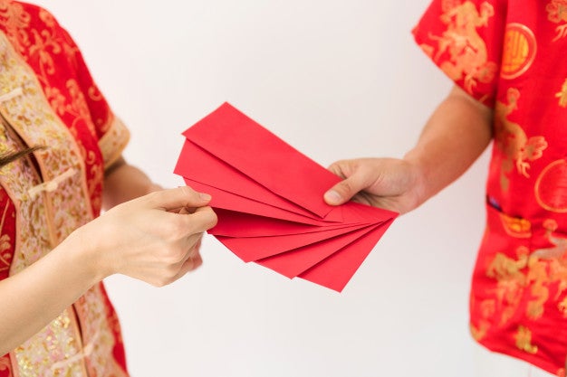 Male Hands Holding Many Blank Red Envelopes With Angpao Money With Chinese Costume 33842 940