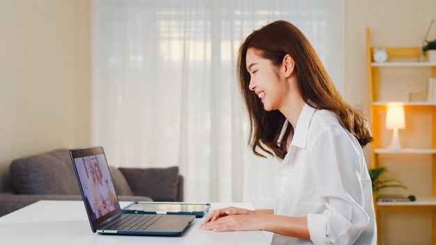 young asian business female using laptop video call talking with family dad mom while working from home living room self isolation social distancing quarantine coronavirus prevention 7861 2753