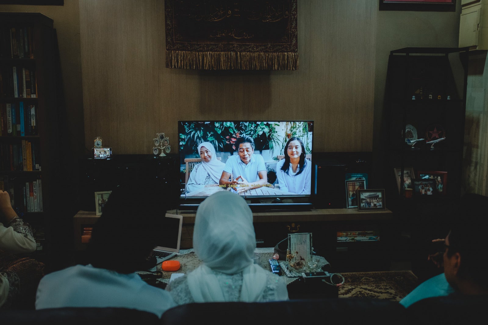 Family watching wedding montage