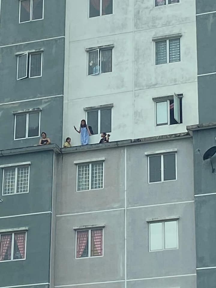 Four women on building ledge