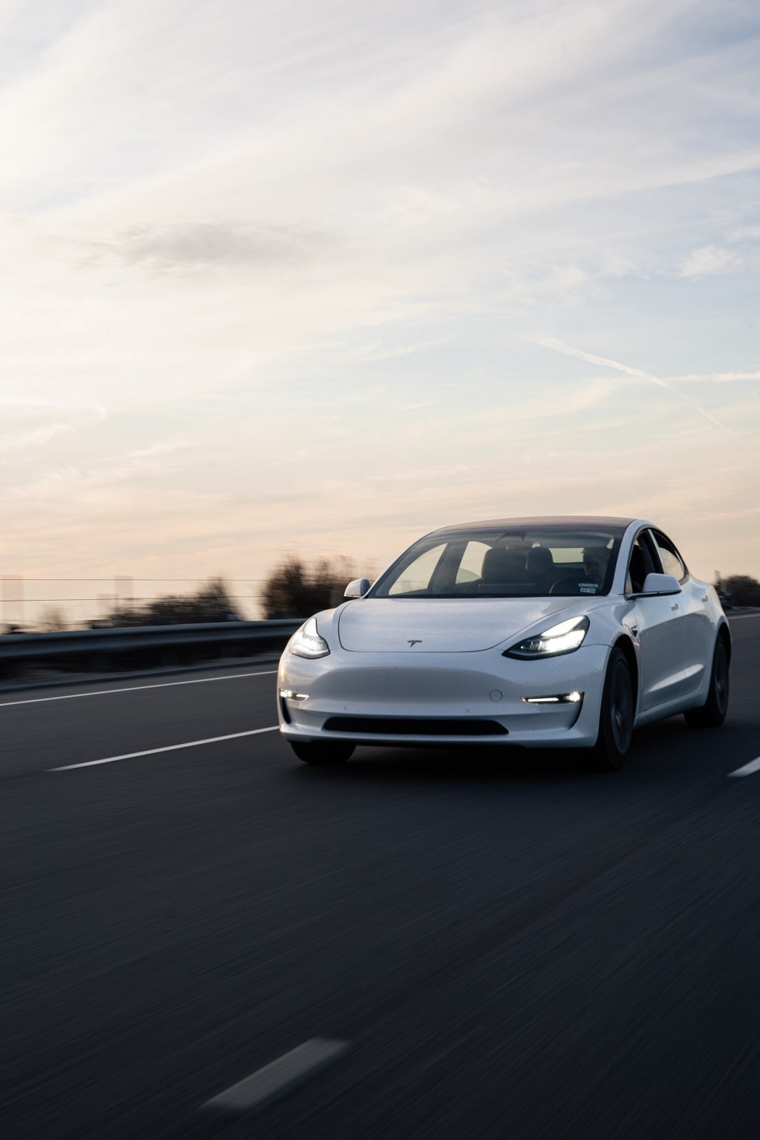 white tesla on the road