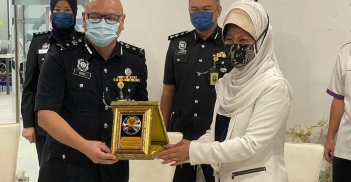 Policeman Giving A Lady A Trophy