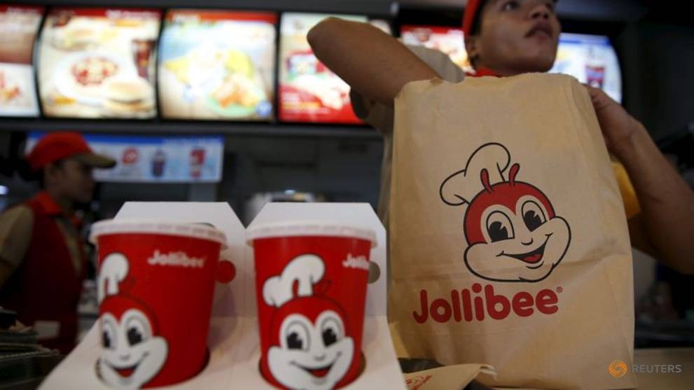 a member of a jollibee crew packs a take away food for a customer inside a jollibee franchise in bf homes paranaque metro manila 1