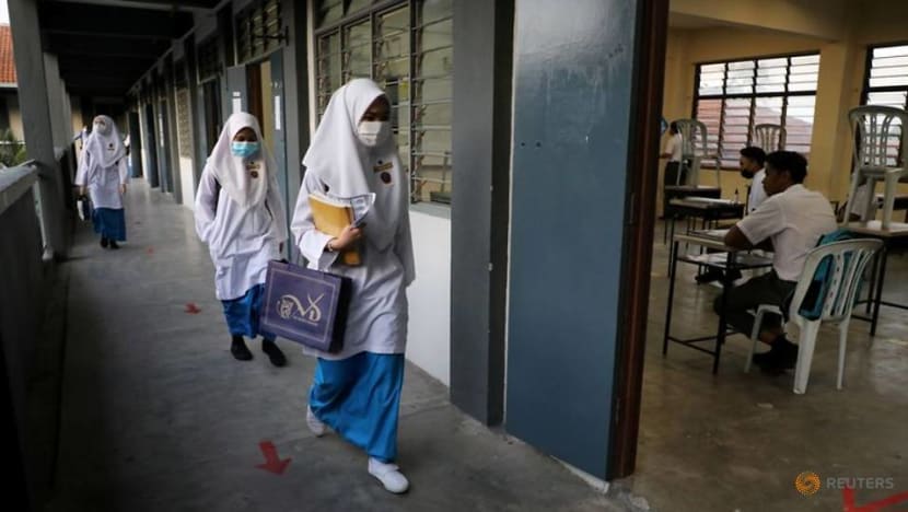 File Photo Students Wearing Protective Masks Walk Past A Classroom At A Secondary School As Schools Reopen Amid The Coronavirus Disease Covid 19 Outbreak In Shah Alam 3