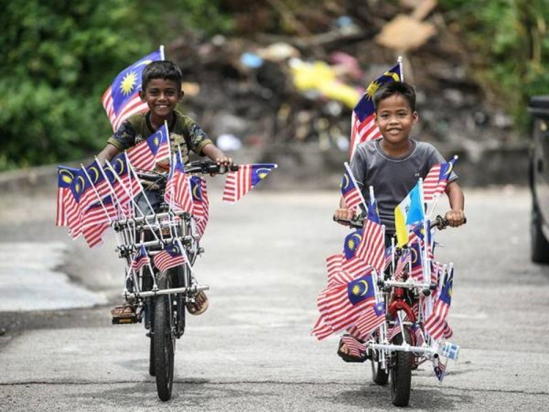 kids with flags on bicycle