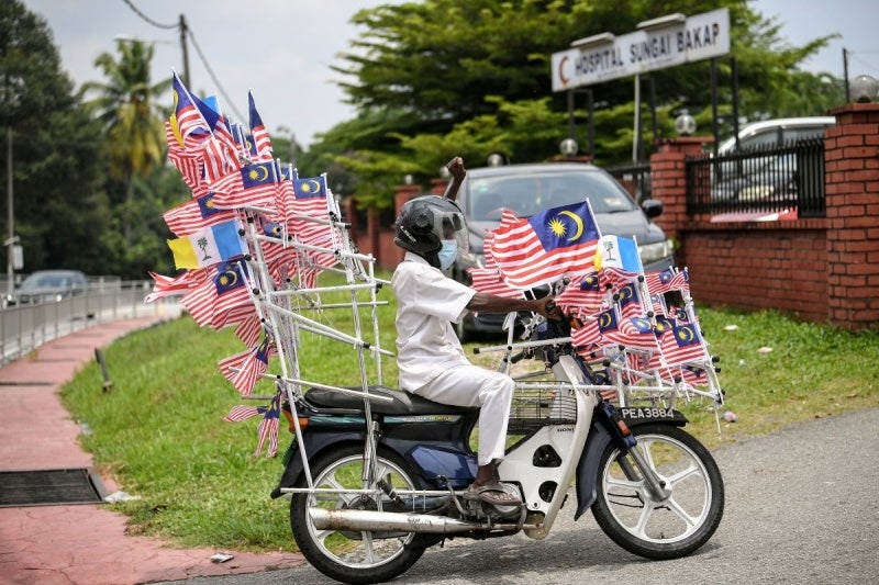 man with flags on motorcycle