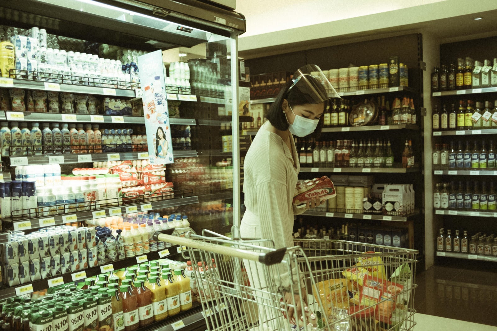 woman in supermarket mask face shield