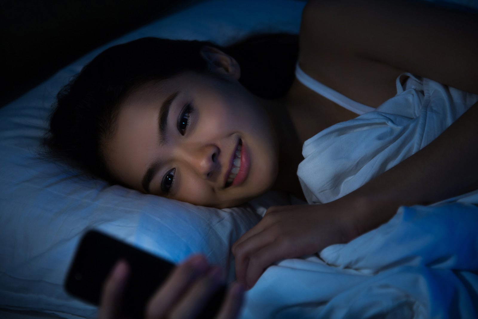 Woman On Bed Using Phone