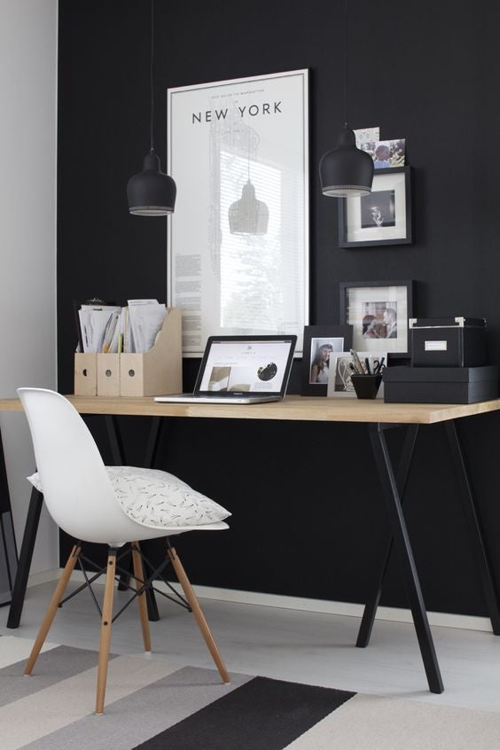 15 a modern Scandi space with a black wall artworks and a wooden desk with black legs