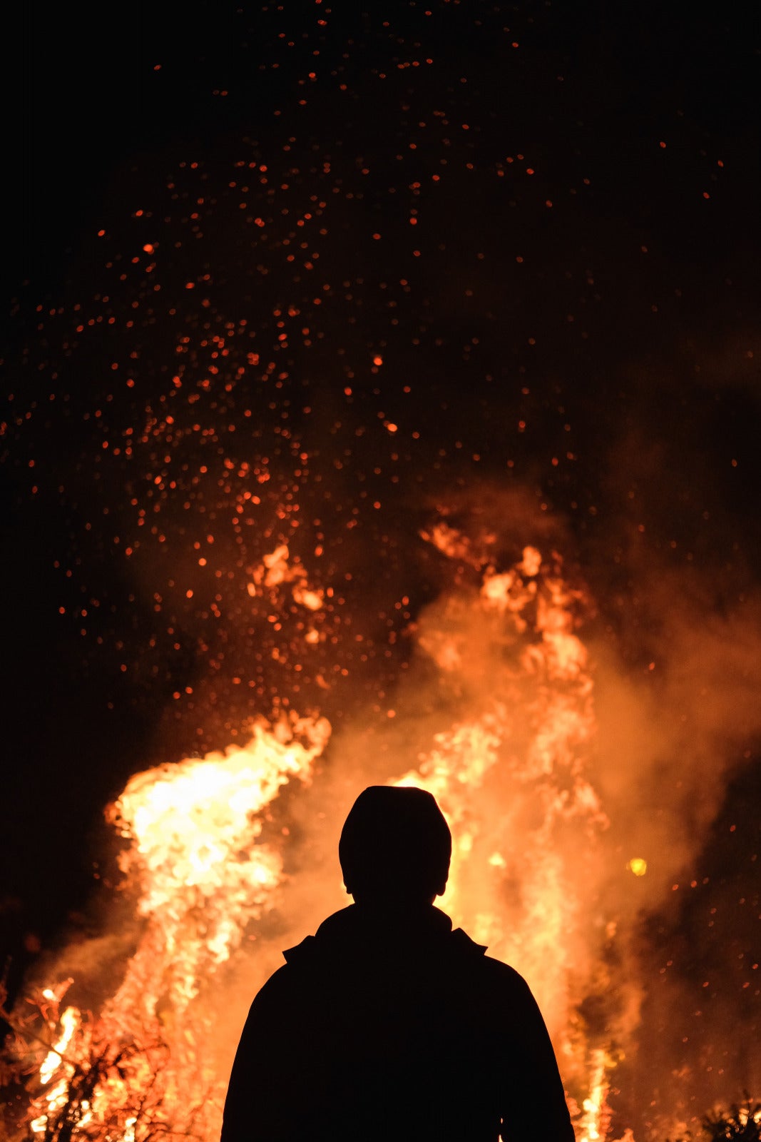 Man In Front Of A Fire