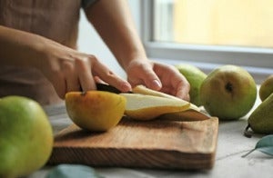 woman cutting ripe pears on 260nw 1114342946