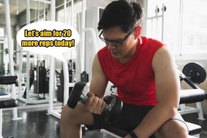 strong muscular asian man workout in gym doing exercises at biceps weight training concept free photo1