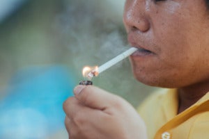 close up man smoking cigarette