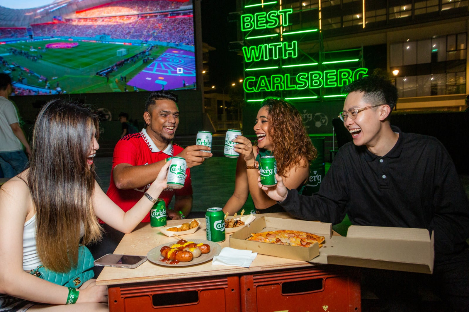 3. Guests enjoying food and brews at Cheers to the Fans Football Viewing Party