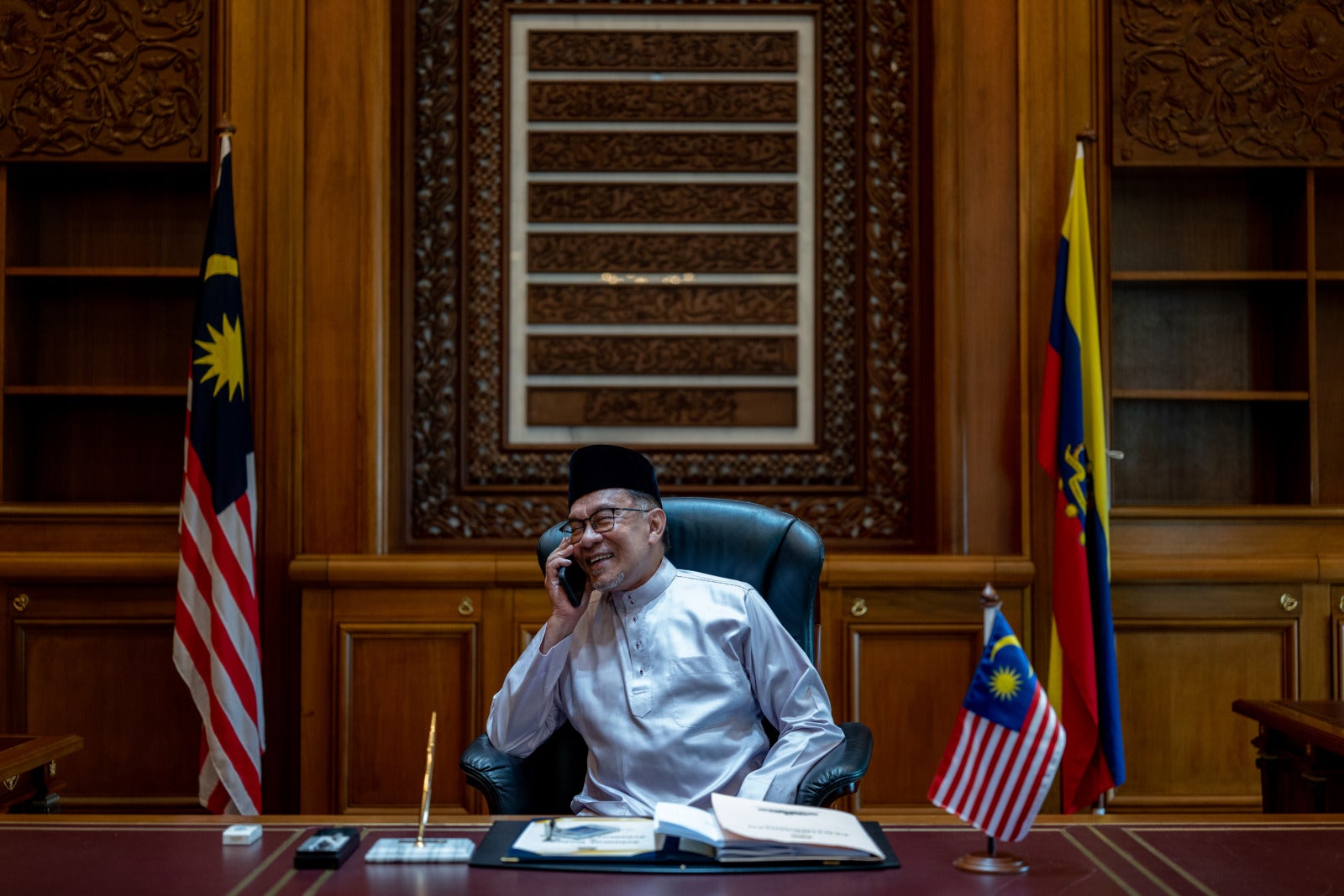 Anwar Ibrahim in office on phone