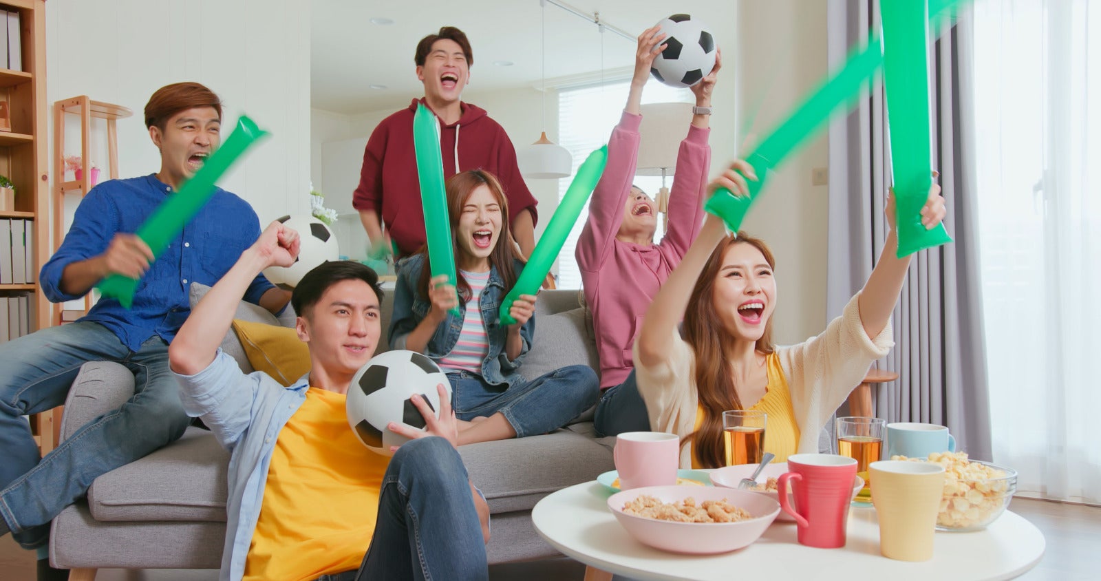 https www.123rf.com photo 185686037 happy asian friends cheer watching live streaming soccer game while scoring goals they wave green th.html