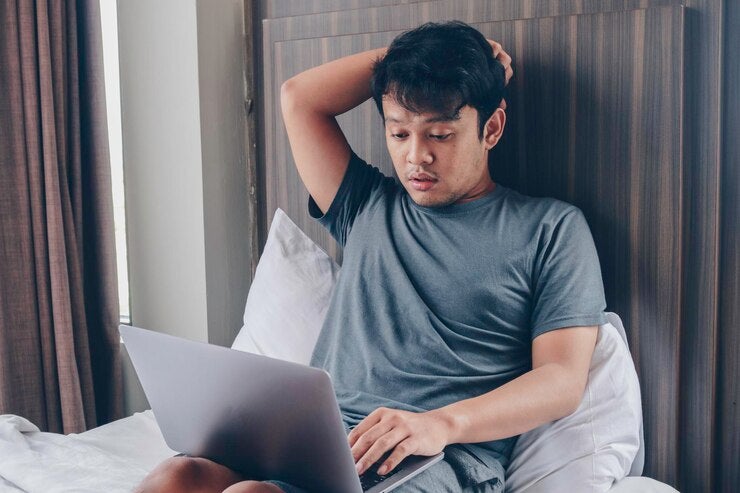 tired stressed young asian man feeling sleepy tired while using laptop bed bedroom hard work concept 216263 841