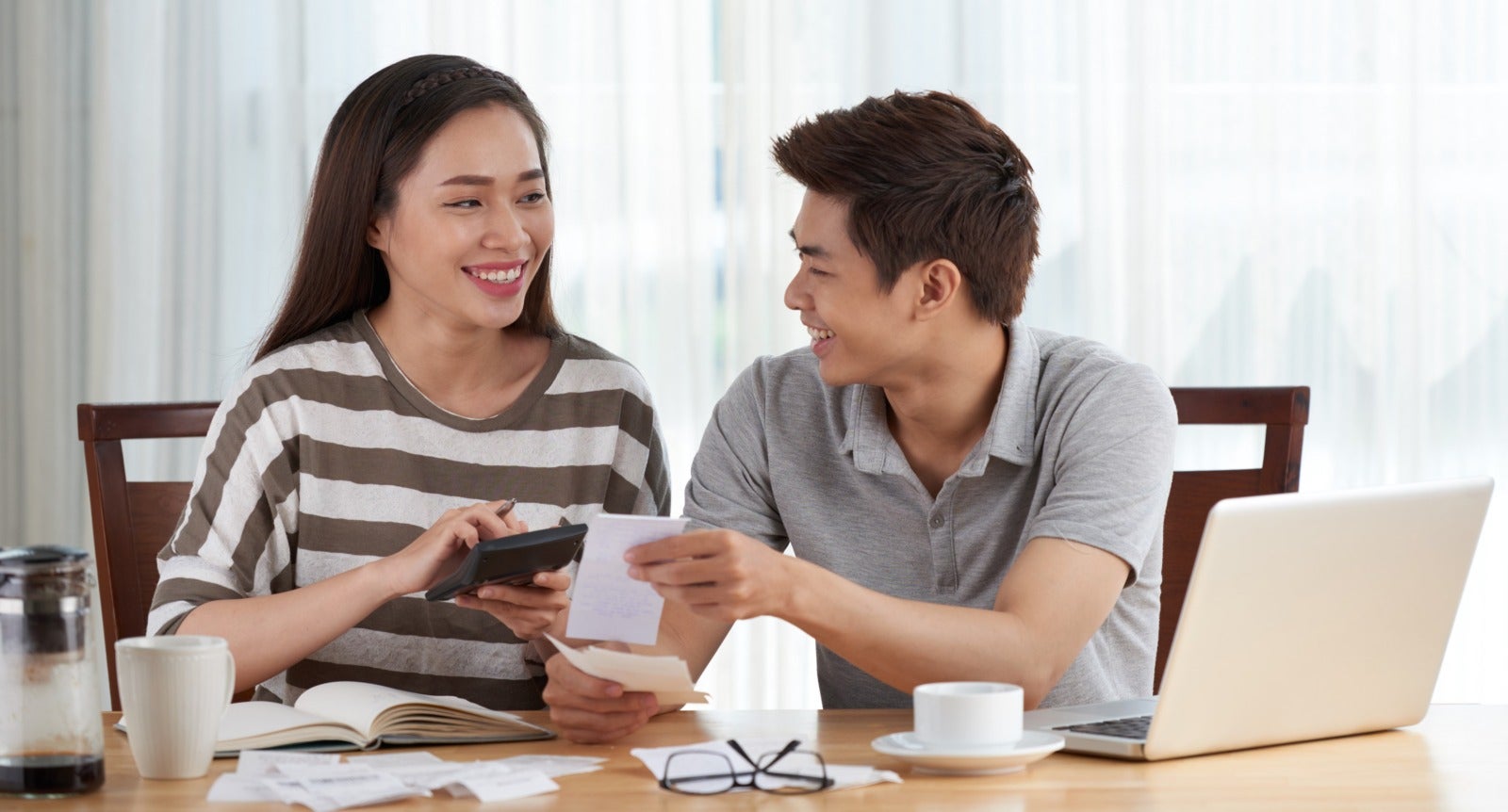 young couple managing family budget home 1