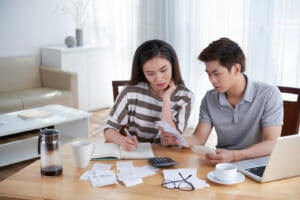 man woman calculating domestic budget home