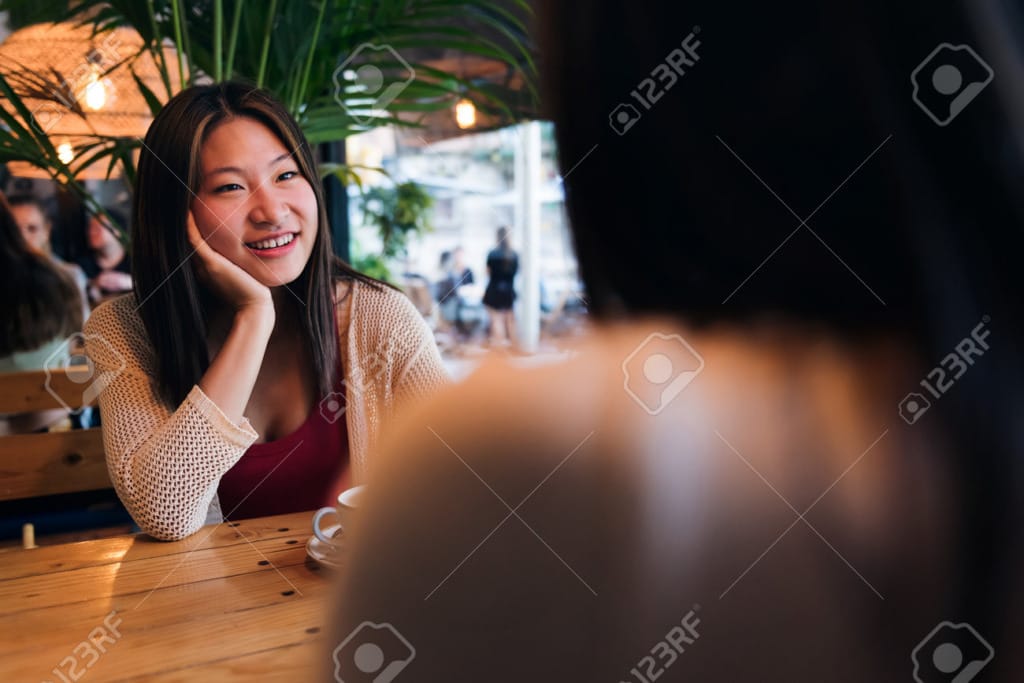 196602242 woman enjoys date with a friend in a coffee shop
