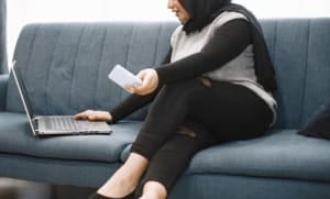modern arab girl hijab using laptop home working remotely while sitting couch living room 1157 49019