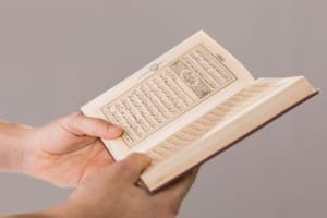 quran being held hands close up 23 2148444089