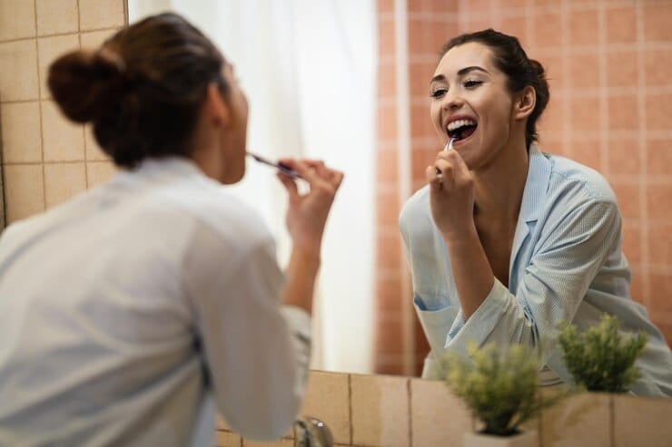 reflection mirror young woman brushing teeth bathroom 637285 3370