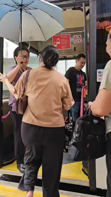 Kind Bus Driver With Umbrella In Singapore 2