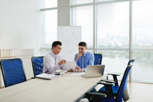 Two Business Executives Negotiating Contract Conference Room