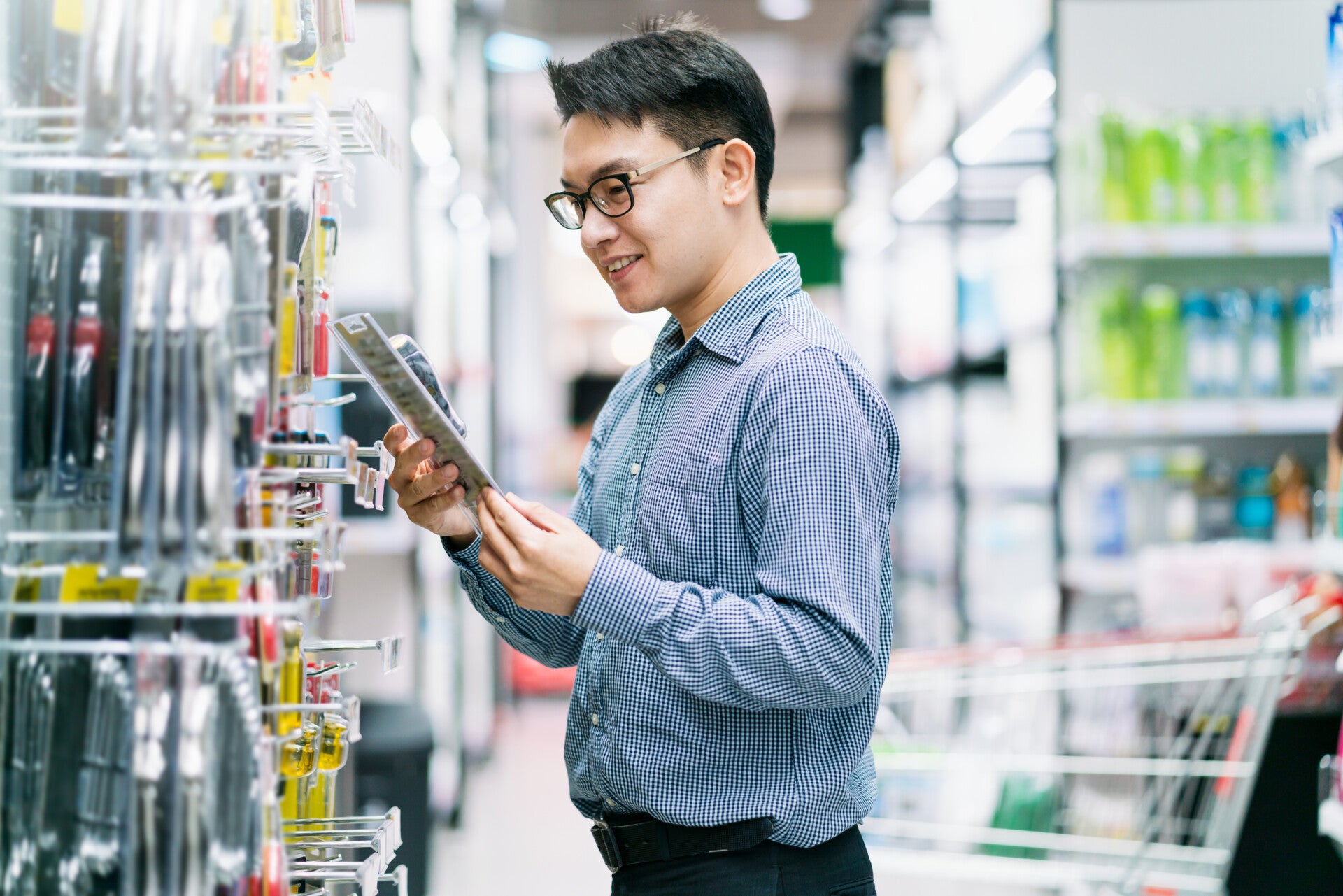 Asian Customer Male Shopping Choose Product From Shelf Store Mall Background