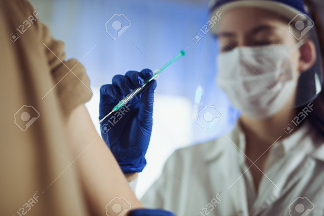 161861457 Female Doctor Or Nurse Giving Shot Or Vaccine To A Patient S Shoulder Vaccination And Prevention