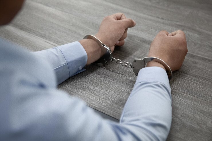 Selective Focus Shot Male Hands Handcuffs Wooden Table 181624 57683