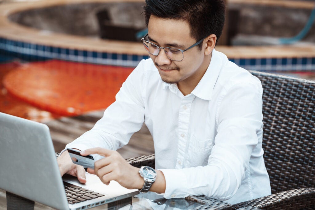 young handsome man enjoy shopping online mobile phone with credit card