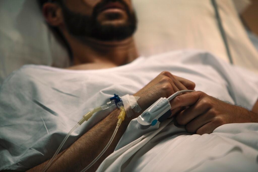 young man being ill hospital bed